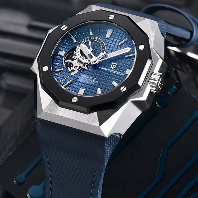 Luxury watch with blue face and strap on a blurred background
