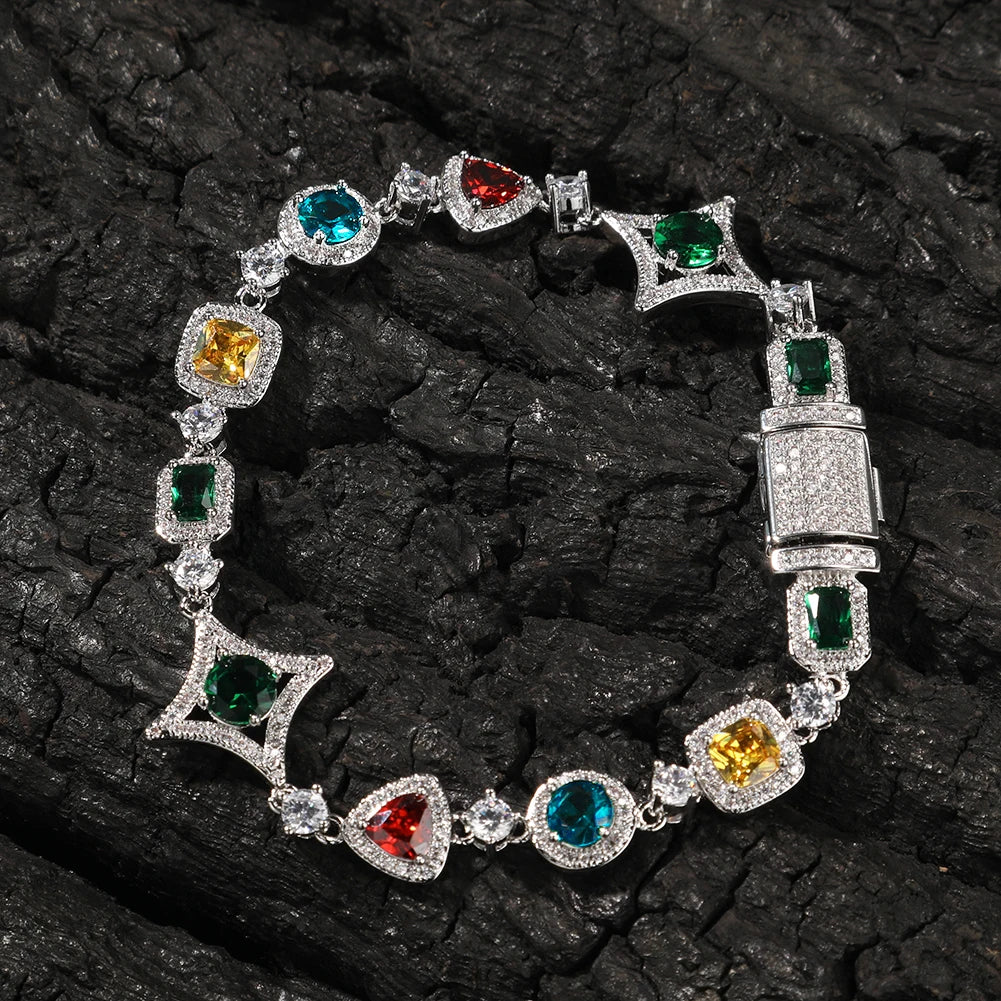 MIMOTTA PARADOX gemstone bracelet in silver tone with red, green, blue and yellow stones on dark wood