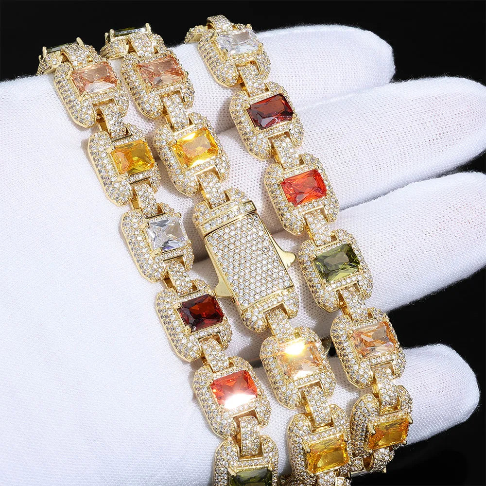 MIMOTTA EMPIRE 12mm iced links in gold tone held in a white glove